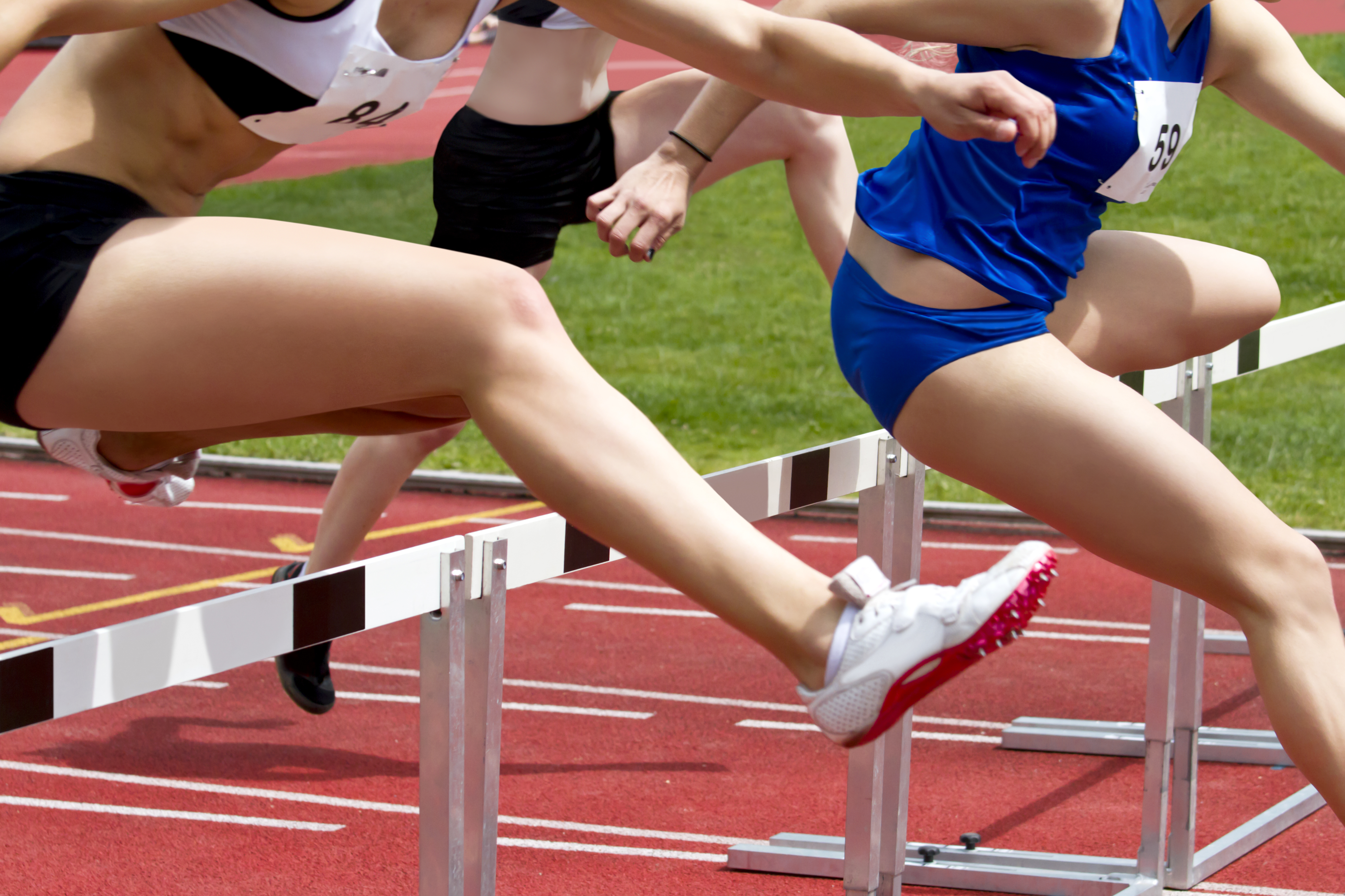 People jumping over hurdles