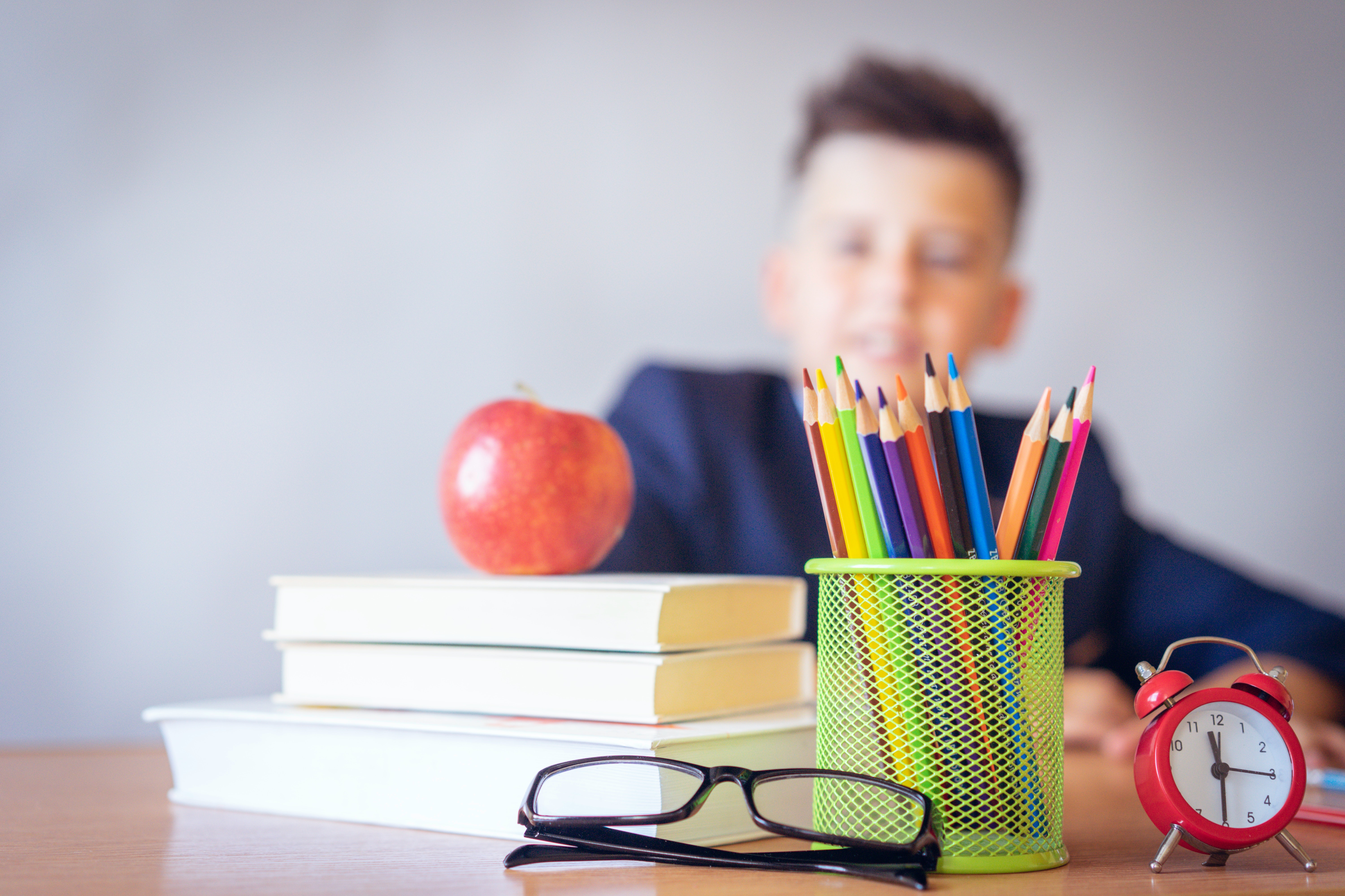 Student at a desk with pencils 