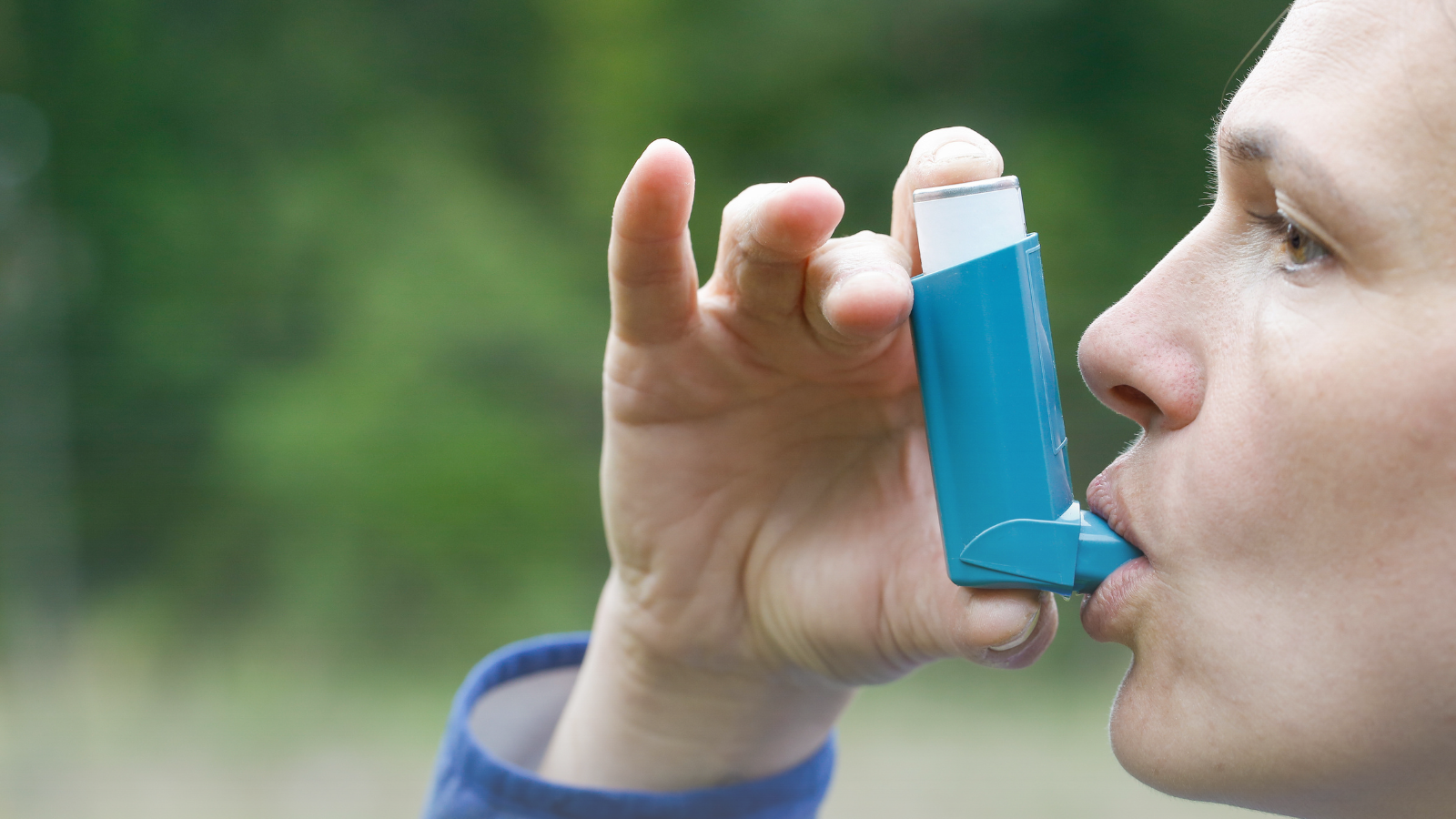 Person using an asthma inhaler